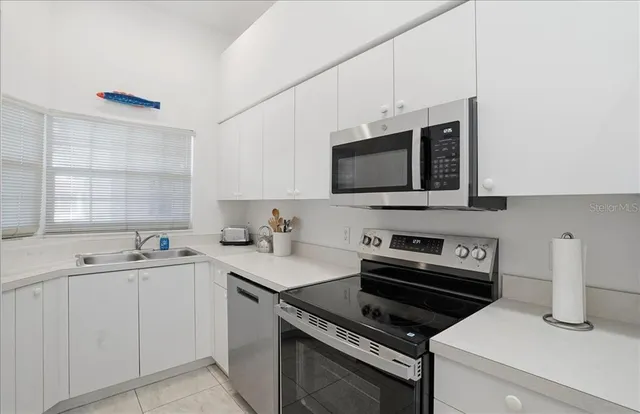 a kitchen with a sink stove and microwave