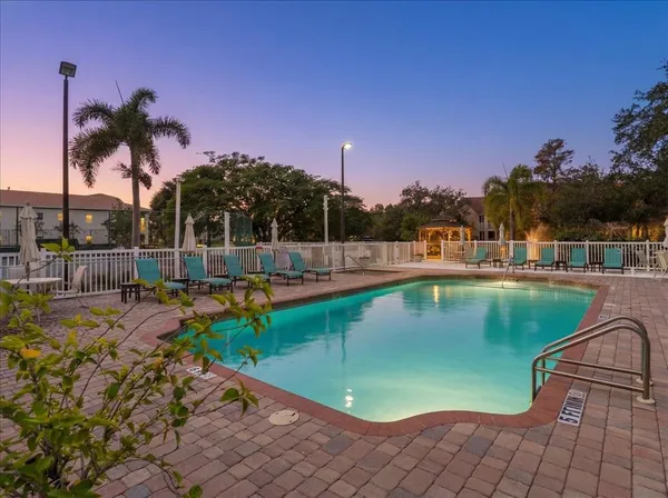 a view of a swimming pool with a lawn chairs