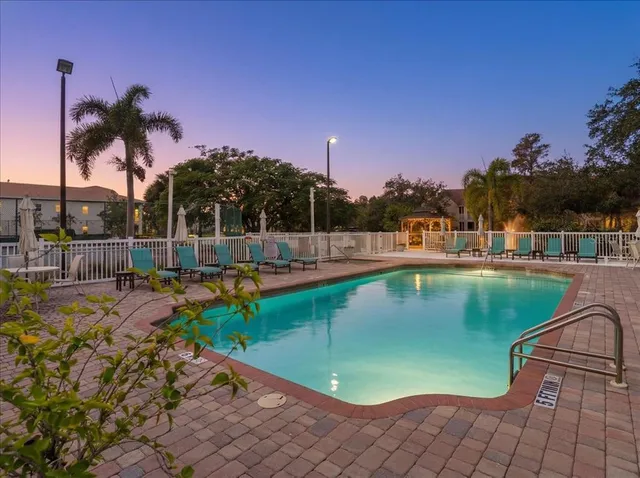 a view of a swimming pool with a lawn chairs