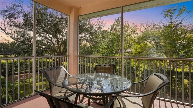 a view of a balcony with chair and wooden floor