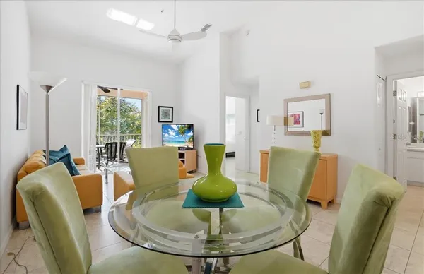 a dining room with furniture a chandelier and wooden floor