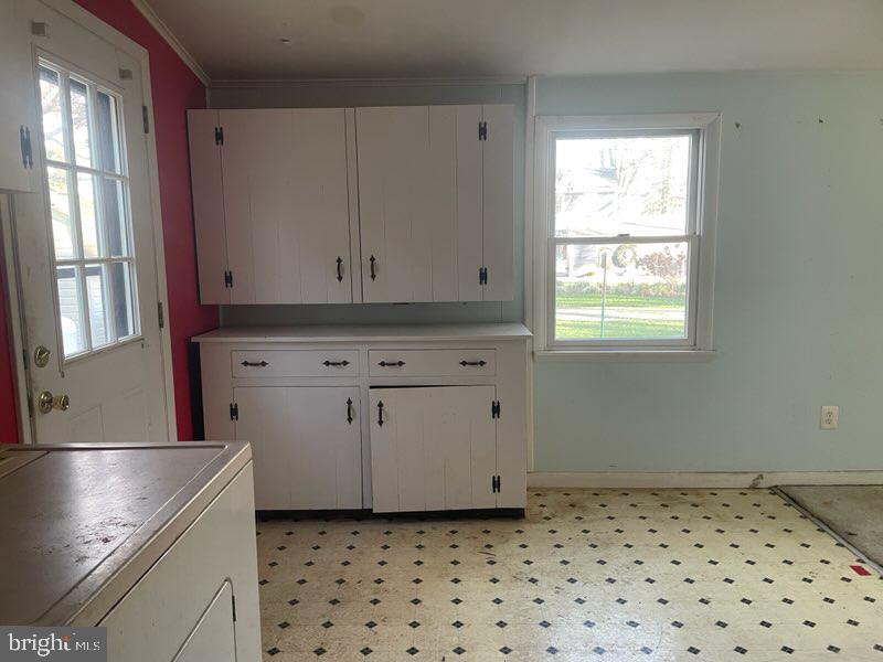 5745 Blaine Road Churchton, MD 20733 - Photo 8 of 9 a kitchen with granite countertop white cabinets and window
