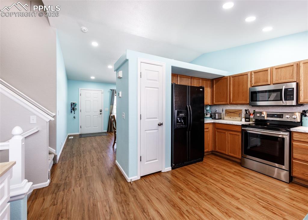12940 Casa De Campo Road Peyton, CO 80831 - Photo 12 of 50 a kitchen with a refrigerator and a microwave