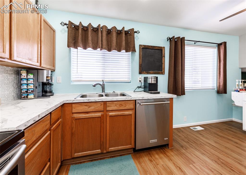 12940 Casa De Campo Road Peyton, CO 80831 - Photo 13 of 50 a kitchen with a sink and wooden floor