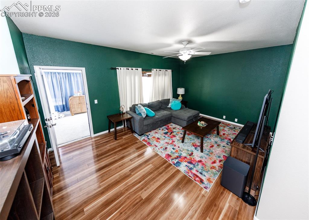 12940 Casa De Campo Road Peyton, CO 80831 - Photo 28 of 50 a living room with furniture and a flat screen tv