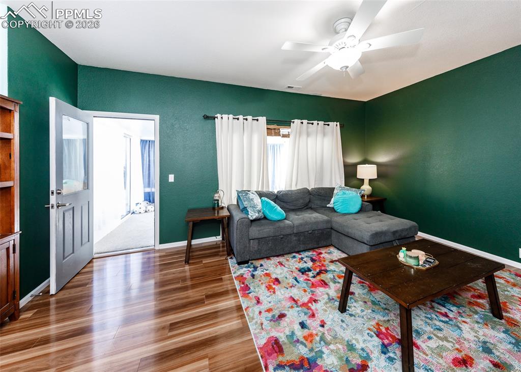 12940 Casa De Campo Road Peyton, CO 80831 - Photo 29 of 50 a living room with furniture and a wooden floor