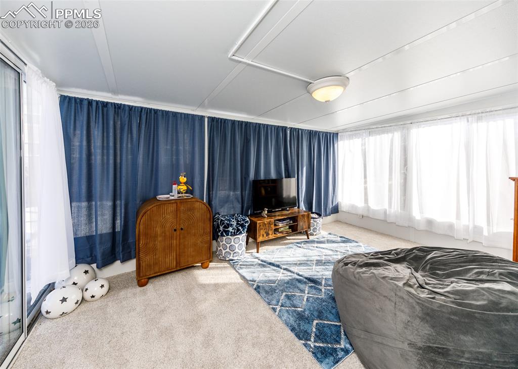 12940 Casa De Campo Road Peyton, CO 80831 - Photo 33 of 50 a bed room with a bed and a chair