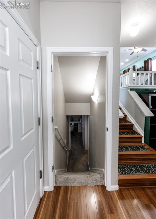 12940 Casa De Campo Road Peyton, CO 80831 - Photo 36 of 50 a view of a hallway view with wooden floor and staircase
