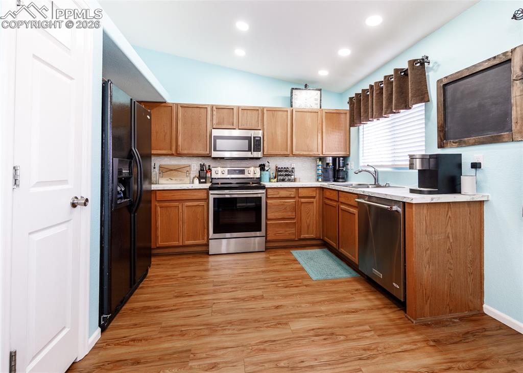 12940 Casa De Campo Road Peyton, CO 80831 - Photo 10 of 50 a kitchen with stainless steel appliances granite countertop a sink stove and refrigerator