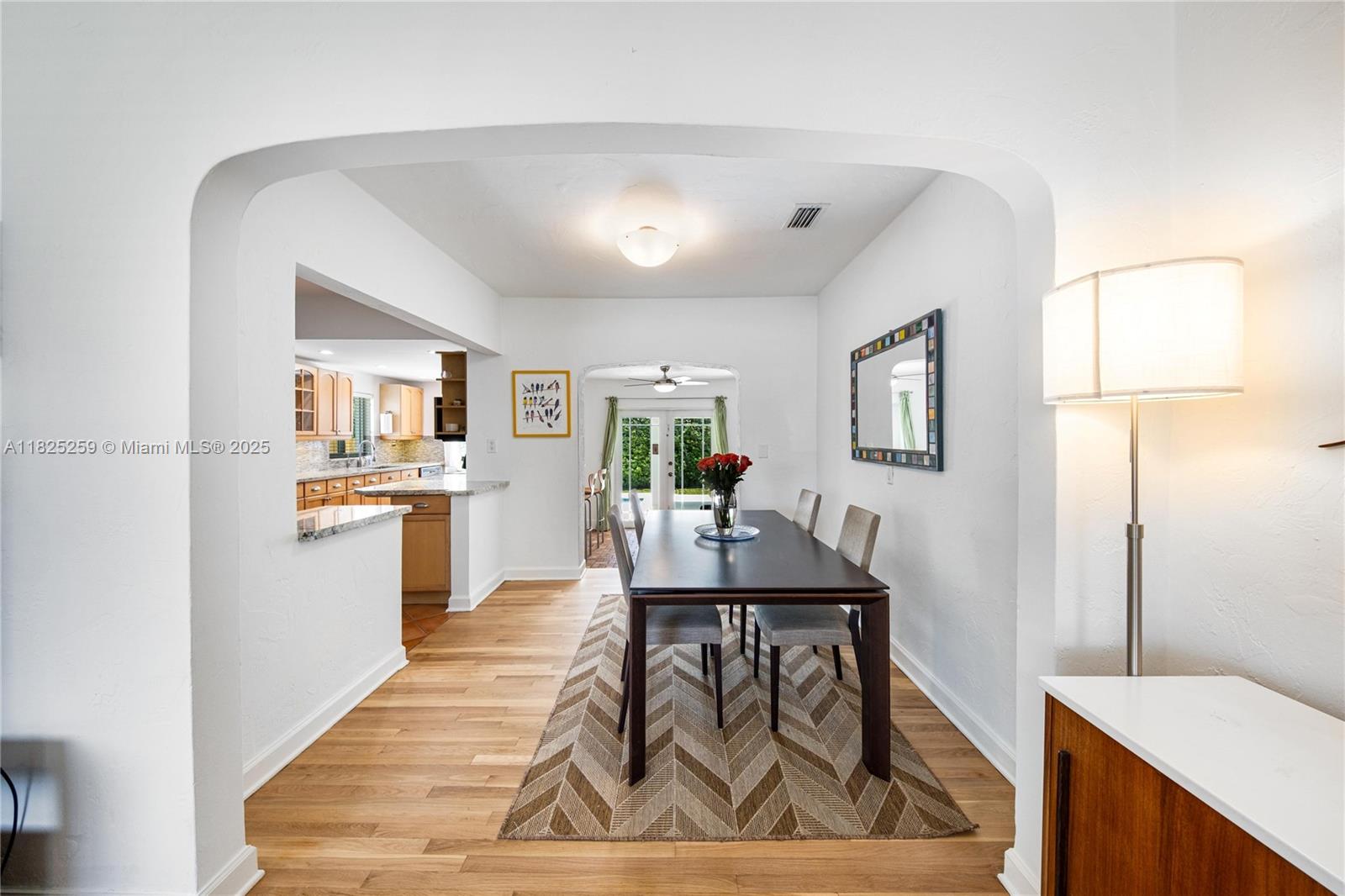 443 Southwest 18th Road Miami, FL 33129 - Photo 11 of 26 a living room with stainless steel appliances kitchen island granite countertop furniture and a wooden floor