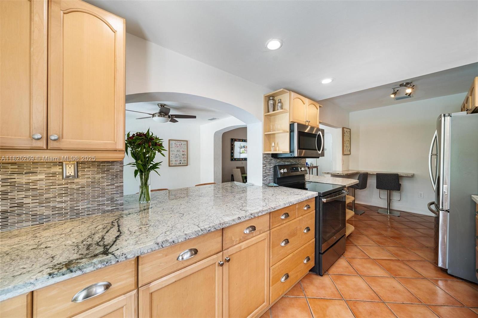 443 Southwest 18th Road Miami, FL 33129 - Photo 12 of 26 a kitchen with stainless steel appliances granite countertop a sink and a refrigerator
