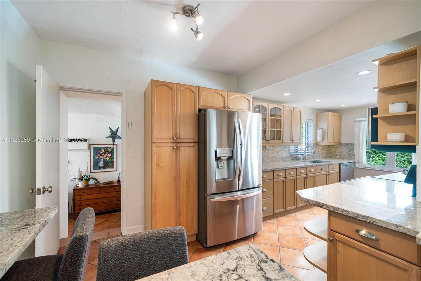 443 Southwest 18th Road Miami, FL 33129 - Photo 13 of 26 a kitchen with stainless steel appliances granite countertop a refrigerator a stove and a sink