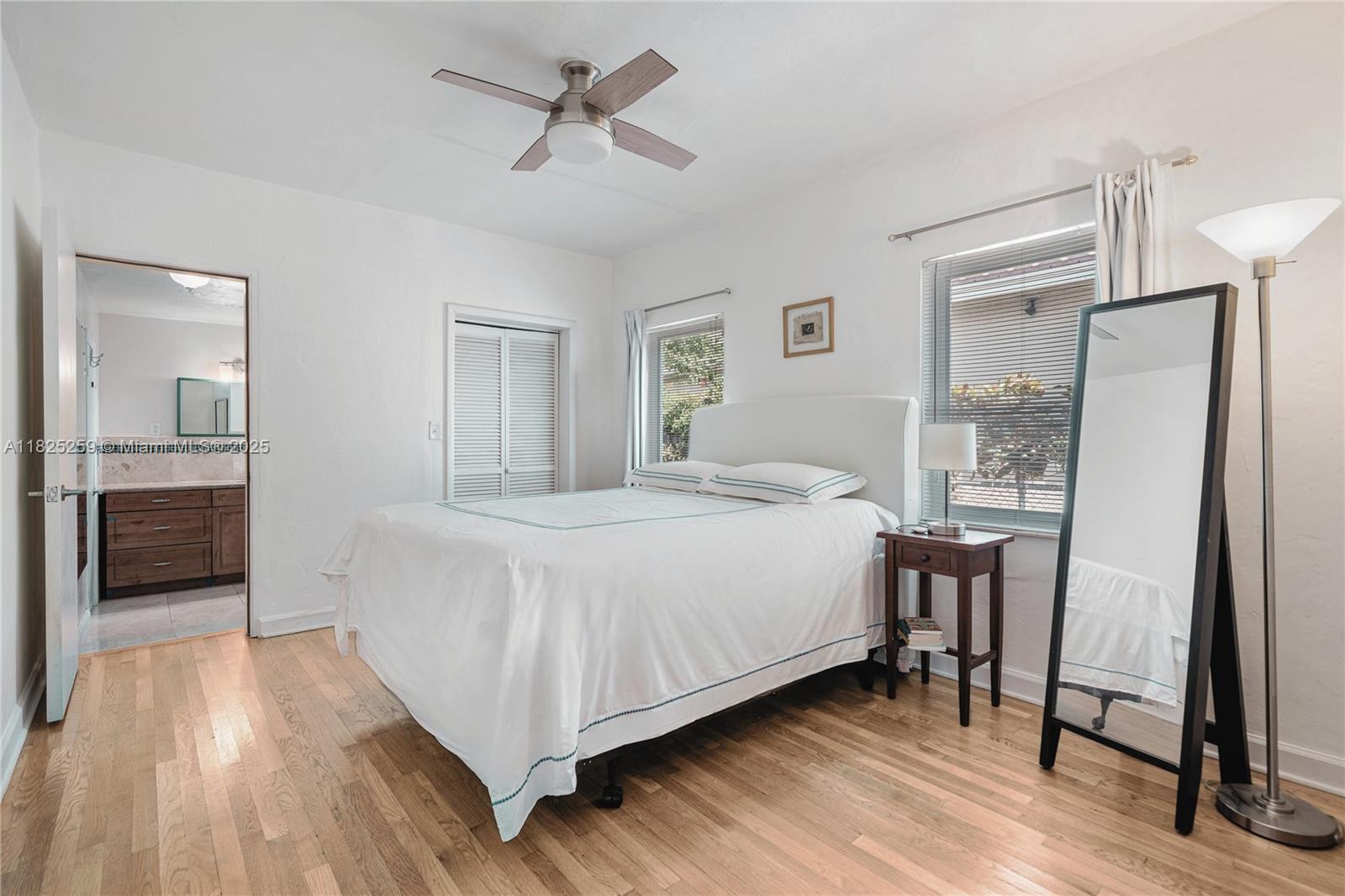 443 Southwest 18th Road Miami, FL 33129 - Photo 16 of 26 a bedroom with a bed and a mirror