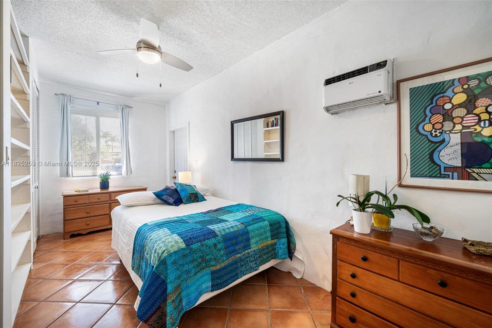 443 Southwest 18th Road Miami, FL 33129 - Photo 20 of 26 a bedroom with a bed and a potted plant on the dresser