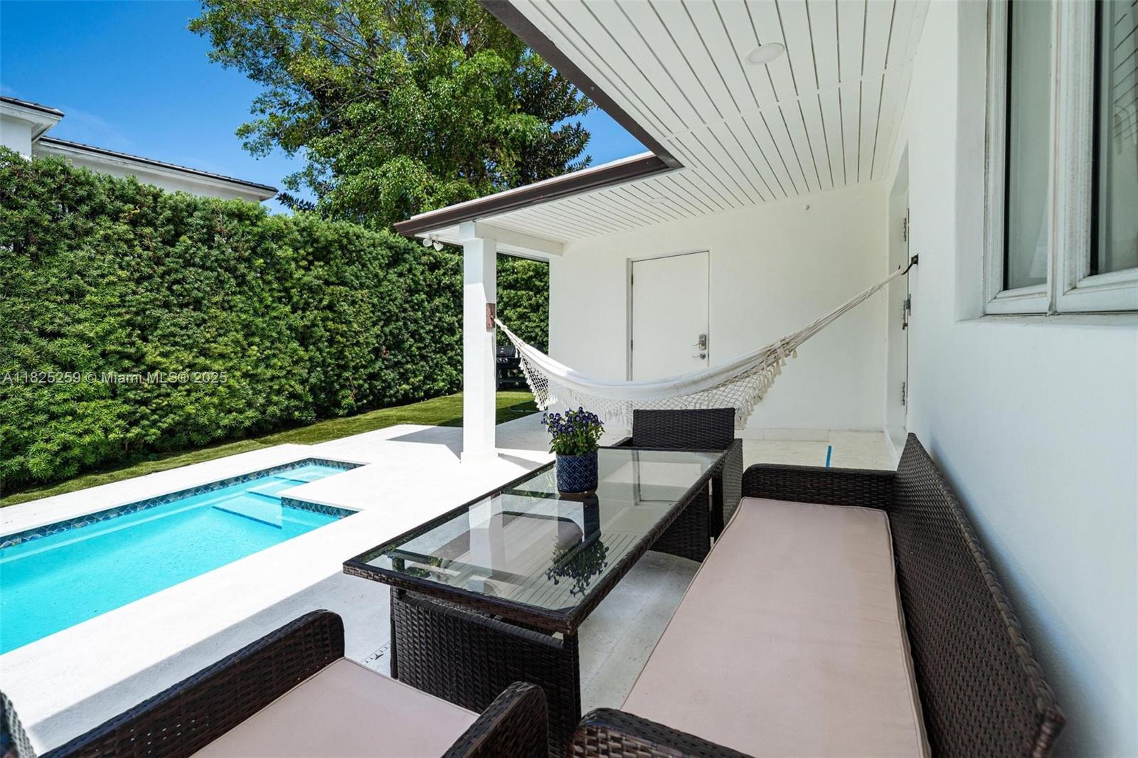 443 Southwest 18th Road Miami, FL 33129 - Photo 5 of 26 a balcony with wooden floor and outdoor seating