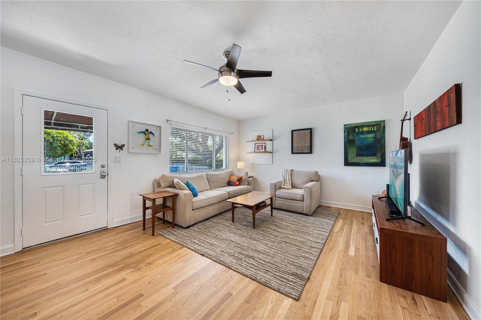 443 Southwest 18th Road Miami, FL 33129 - Photo 9 of 26 a living room with furniture and a flat screen tv