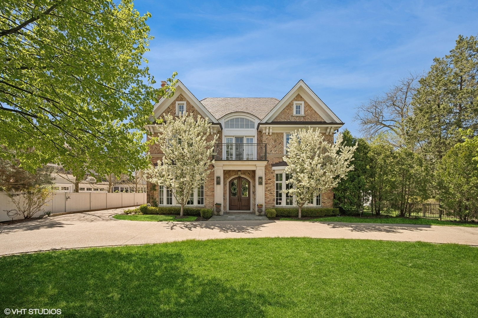 1228 Westmoor Road Winnetka, IL 60093 - Photo 1 of 70 a front view of a house with a garden