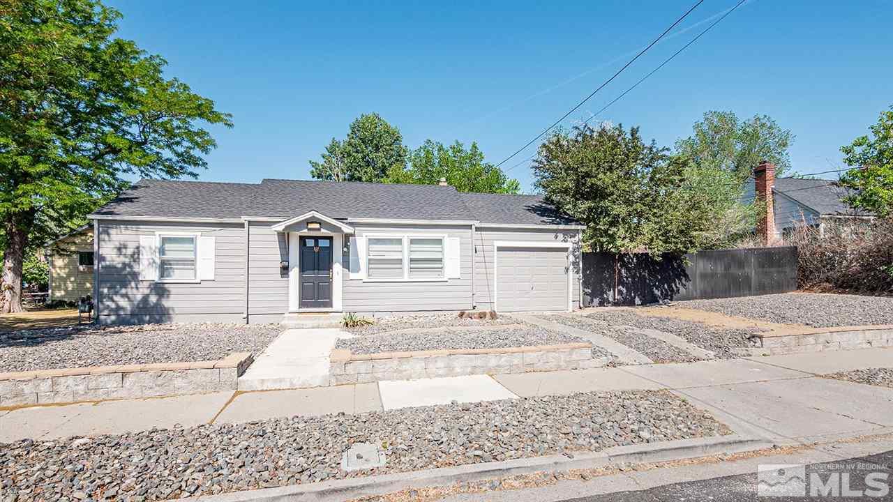 1201 Ralston Street Reno, NV 89503 - Photo 3 of 8 a view of a white house with a small yard and large trees