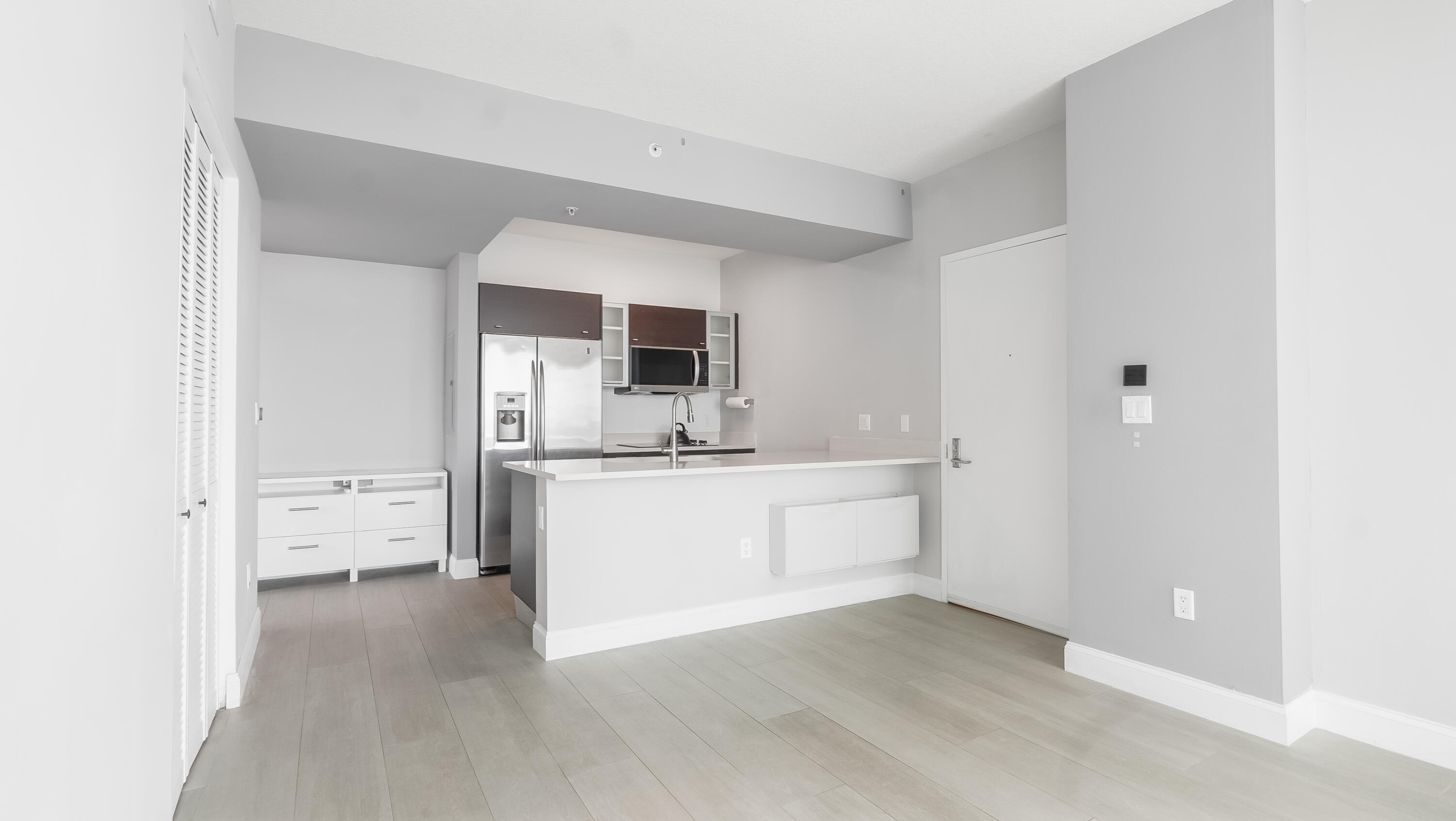 333 Northeast 24th Street, Unit 1102 Miami, FL 33137 - Photo 11 of 51 a large white kitchen with a sink