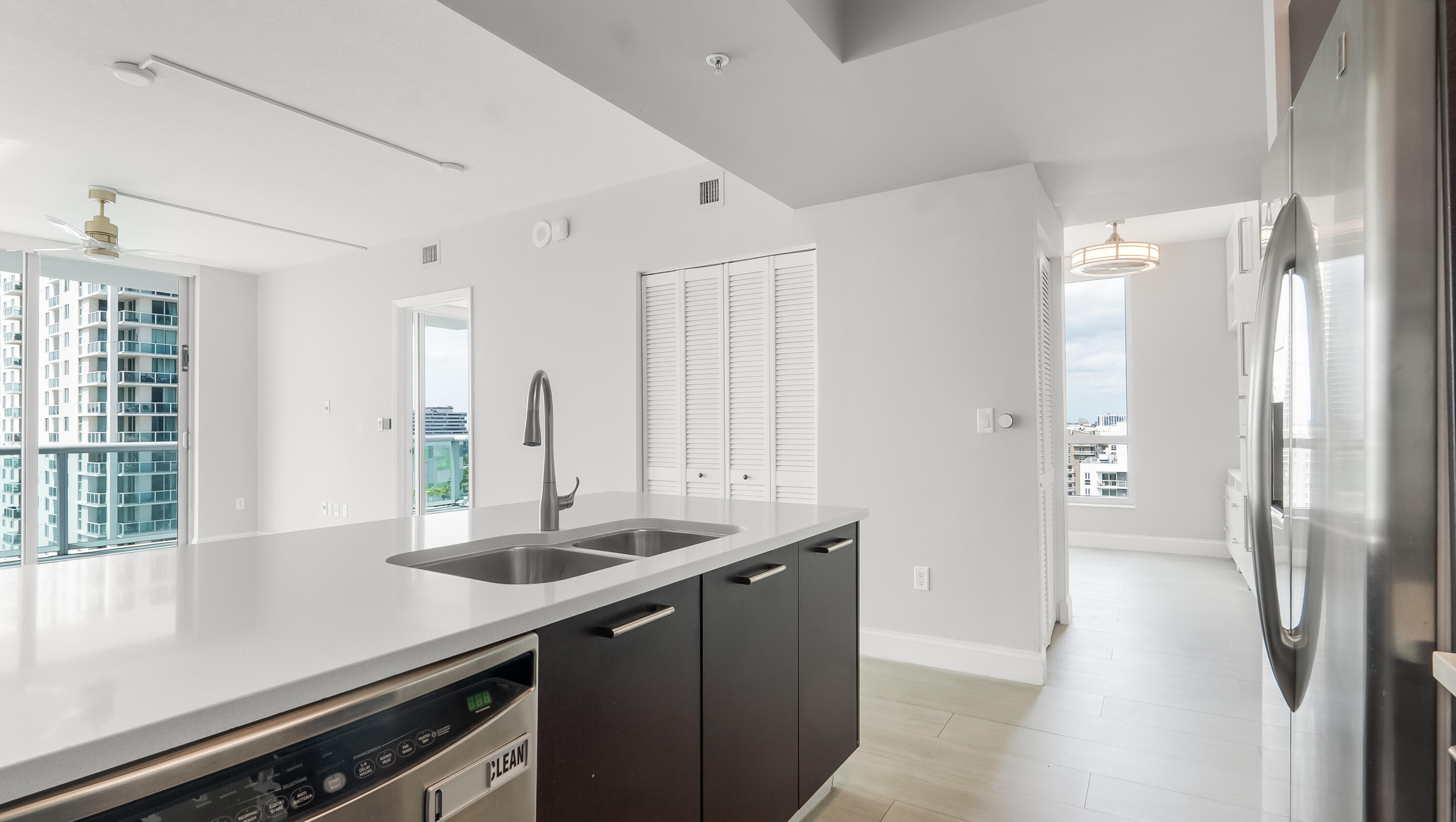 333 Northeast 24th Street, Unit 1102 Miami, FL 33137 - Photo 16 of 51 a kitchen with stainless steel appliances granite countertop a sink and a refrigerator