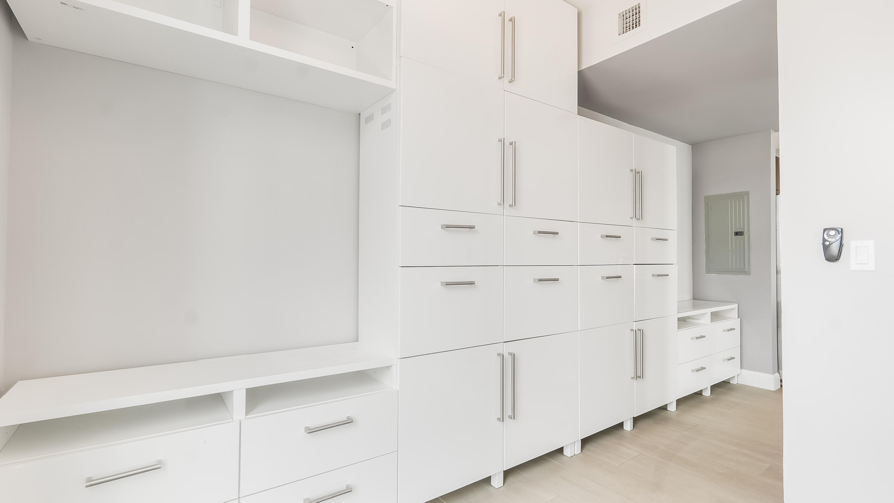 333 Northeast 24th Street, Unit 1102 Miami, FL 33137 - Photo 20 of 51 a kitchen with white cabinets and white appliances