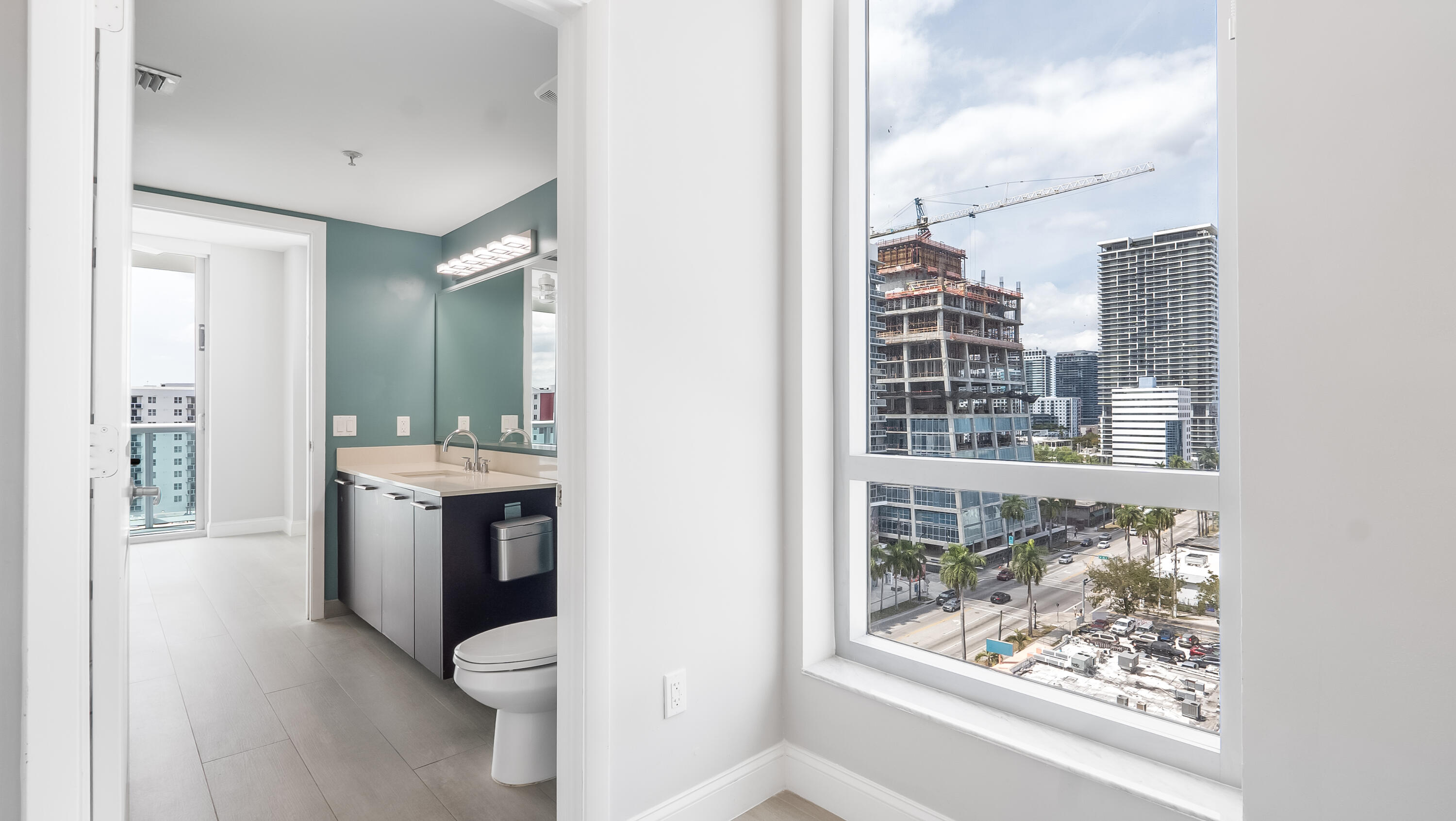 333 Northeast 24th Street, Unit 1102 Miami, FL 33137 - Photo 21 of 51 a bathroom with a toilet sink and mirror