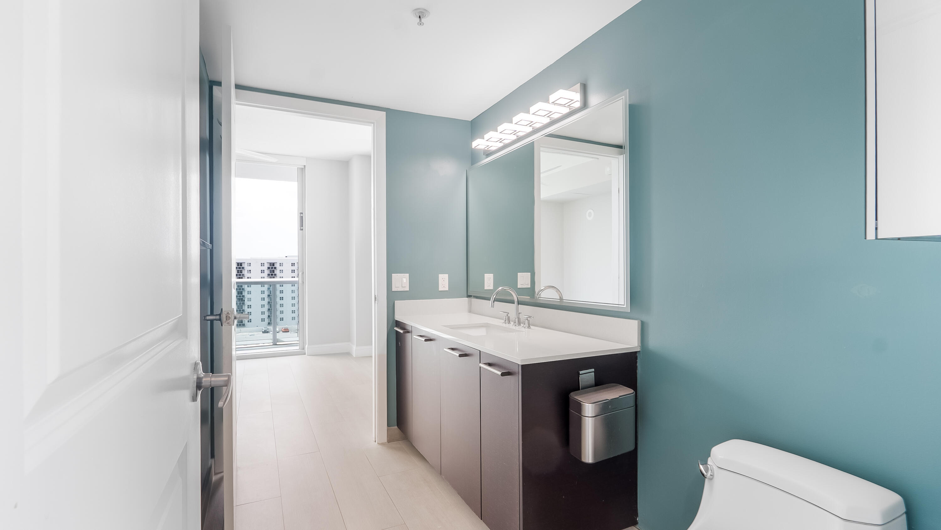 333 Northeast 24th Street, Unit 1102 Miami, FL 33137 - Photo 22 of 51 a bathroom with a toilet sink and mirror