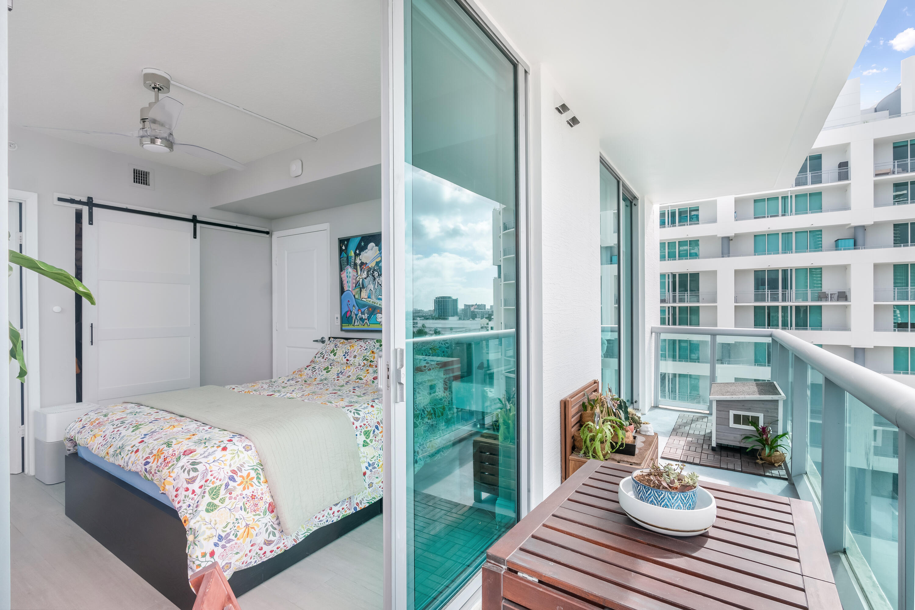 333 Northeast 24th Street, Unit 1102 Miami, FL 33137 - Photo 33 of 51 a bedroom with a bed and a table with garden view