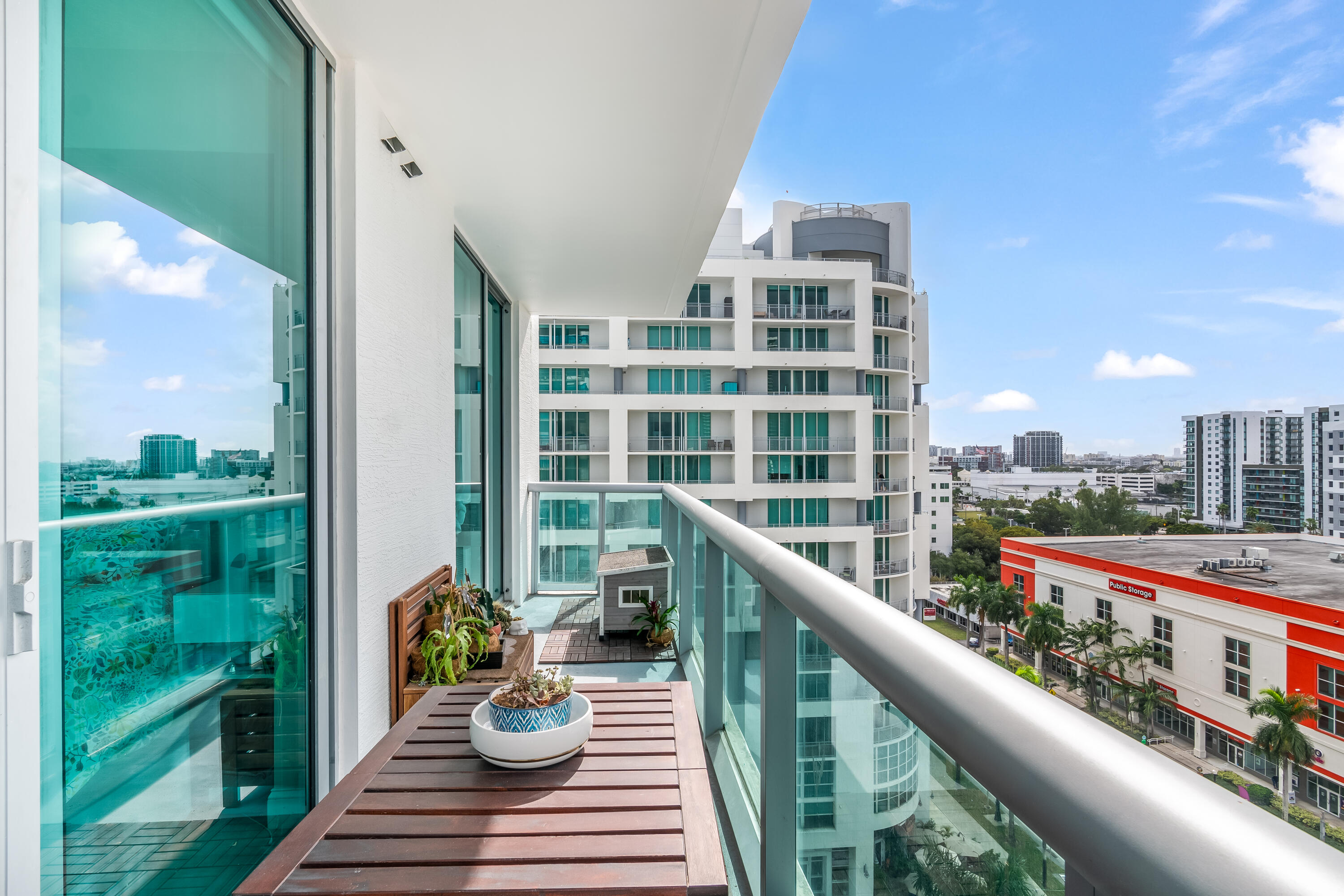 333 Northeast 24th Street, Unit 1102 Miami, FL 33137 - Photo 34 of 51 a balcony with wooden floor and outdoor seating
