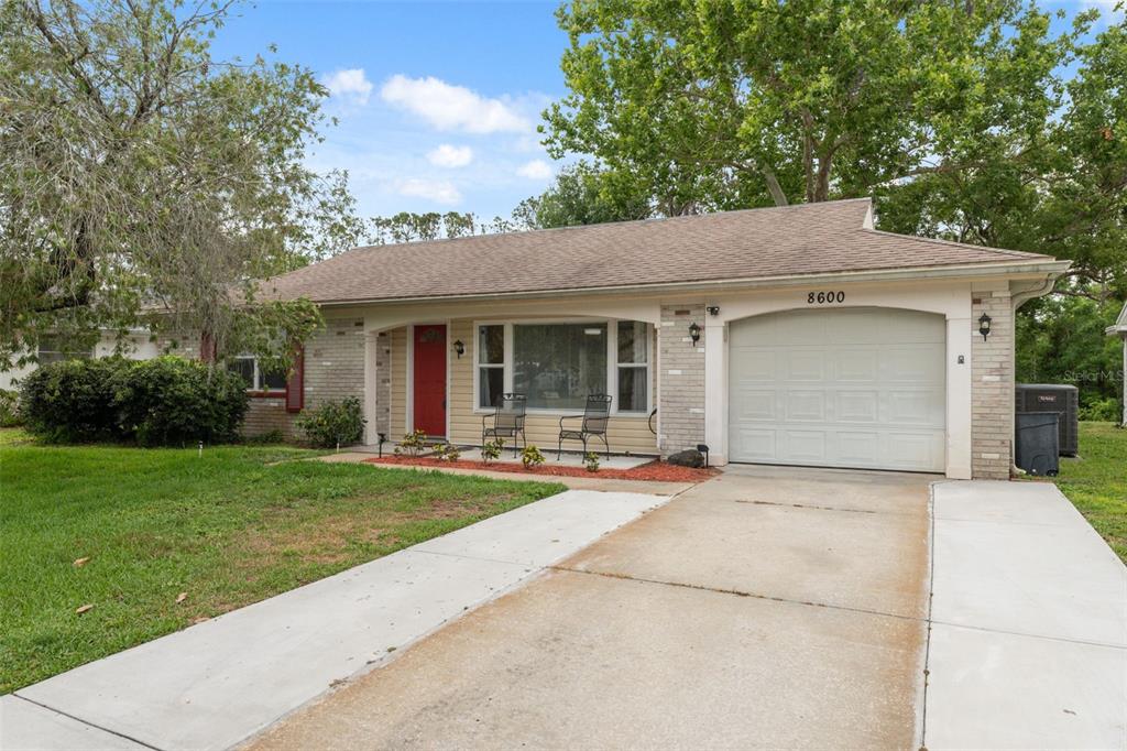 a front view of a house with yard and green space