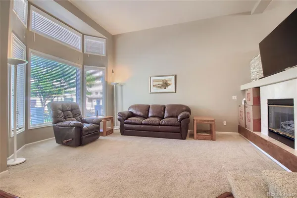 a bedroom with a bed flat screen tv and a chandelier