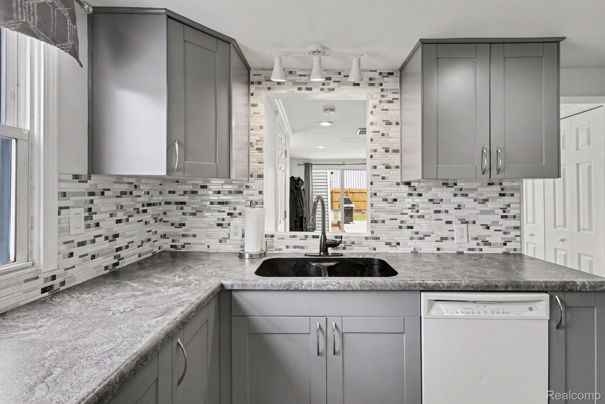 16485 Jennings Road Fenton, MI 48430 - Photo 13 of 27 Kitchen featuring gray cabinetry and dishwasher