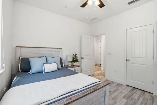 a bedroom with a bed and a chandelier