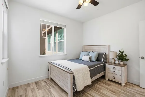 a bedroom with a large bed and a window