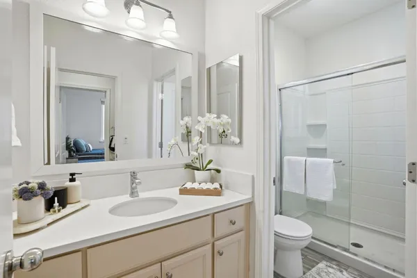 a bathroom with a sink a toilet and shower