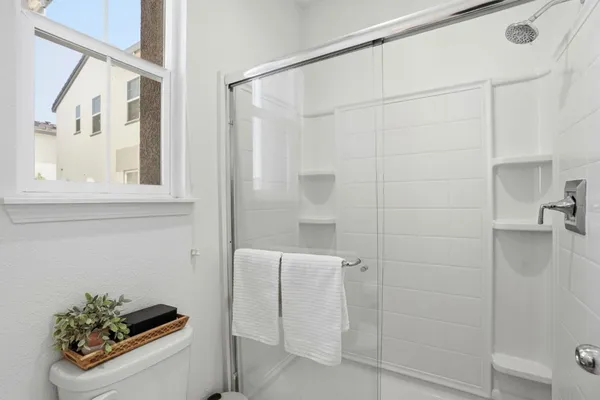 a bathroom with a shower and a sink