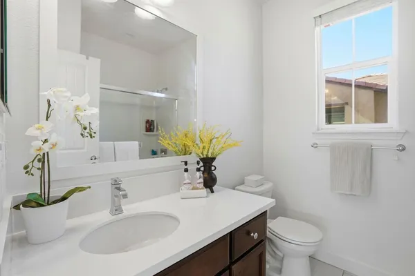 a bathroom with a sink toilet and a mirror