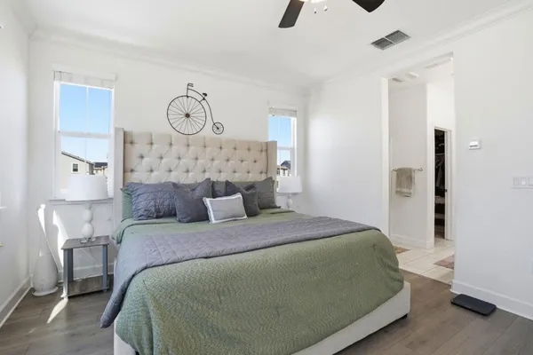 a bedroom with a bed and ceiling fan