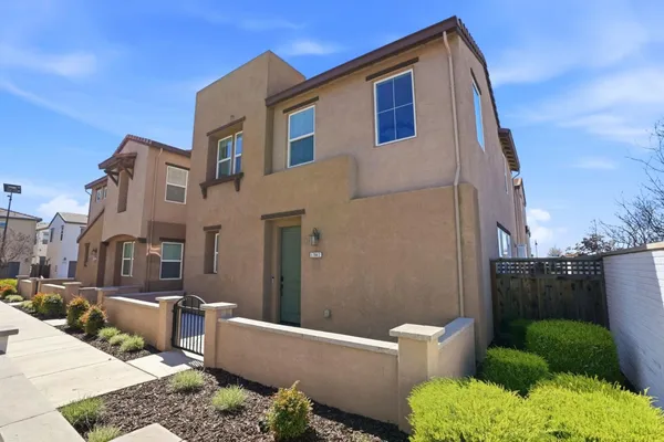 a backyard of a house with outdoor seating