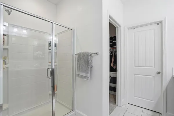 a bathroom with a glass shower door