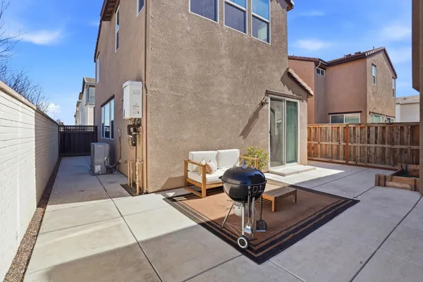 a view of a patio with a table and chairs