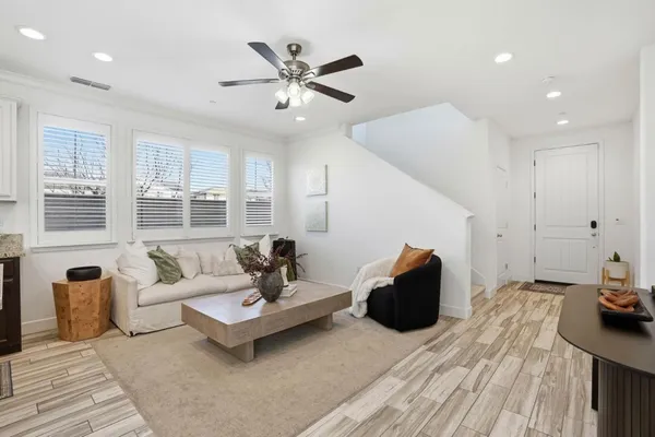 a living room with furniture and wooden floor