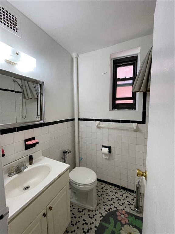 877 Bay Ridge Avenue, Unit 1A Brooklyn, NY 11220 - Photo 6 of 6 a bathroom with a sink a toilet and mirror