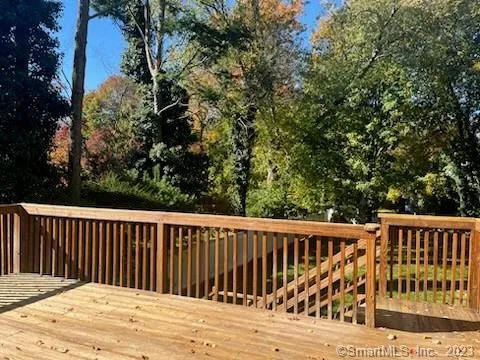a roof deck view with wooden floor and fence