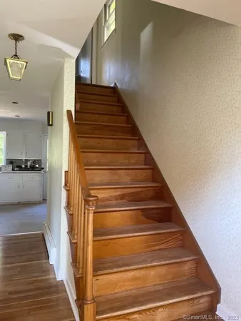 a view of entryway and hall with wooden floor