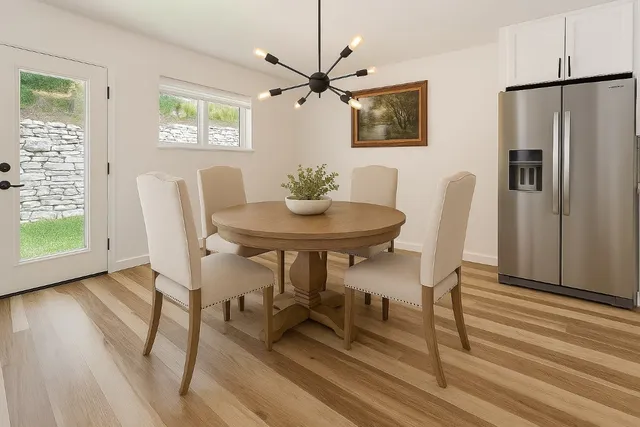 a view of a dining room with furniture window and wooden floor