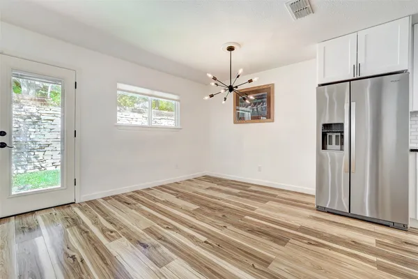 a kitchen with stainless steel appliances granite countertop a refrigerator a stove and a sink