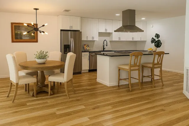 a kitchen with granite countertop white cabinets and stainless steel appliances