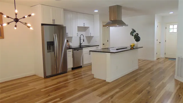 a kitchen with stainless steel appliances a refrigerator and a stove