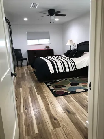 a bed room with a bed and a television